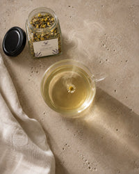 Calm and Balance tea brewed — golden postpartum wellness infusion overhead view