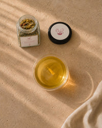 Mother's Recovery tea brewed — golden postpartum herbal infusion overhead view